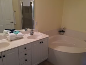Master bath with garden tub, separate shower, and double vanity.
