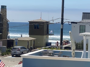 Ocean view from 2nd floor patio, that's the 25th St Lifeguard tower + bathrooms
