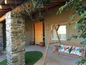 Front entry and porch with swing chair.  Perfect spot to read a book!