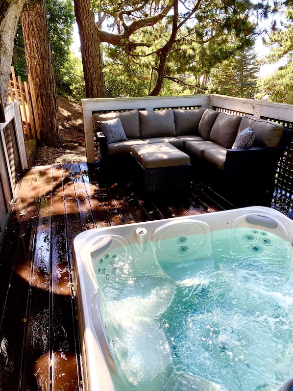  a decked hot tub and a grand oak and festive lighting