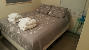 Queen bed with TV in room