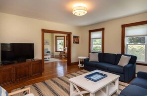 Living room with 50" HDTV connects to Den
