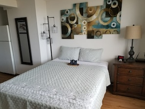 studio A with queen bed and night stand dresser
