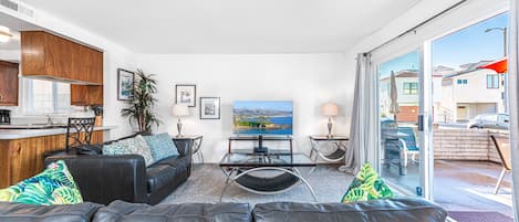 View of main living spaces from the front entry. Open floor plan between living, kitchen and dining areas.