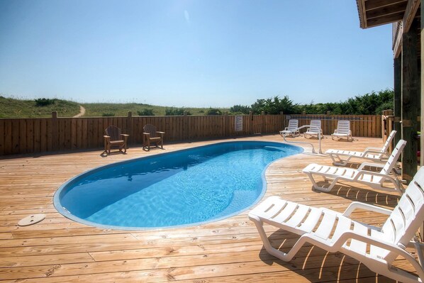 Sparkling pool with seating ideal for tanning and relaxation.