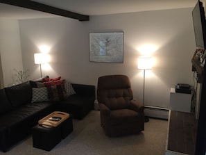 View of open area with couch and recliner chair