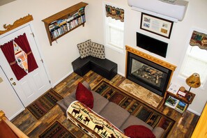 Living Room with Roku TV, DVDs, and gas fireplace.