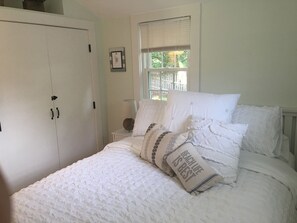 Bdrm 1 is airy and light with a queen bed, nice closet and TV