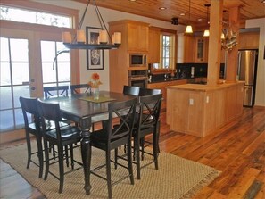 Kitchen and dining with views of the woods