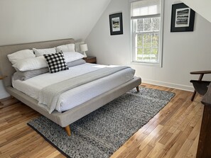 Master bedroom features cal king memory foam bed and small built-in garment rack