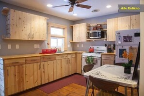 Natural wood, custom kitchen, seating four. 