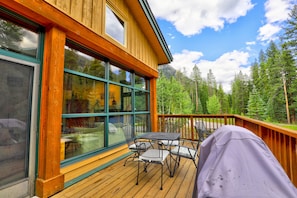 Spacious deck, woods and river behind