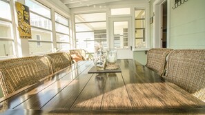 Seating for six in the porch;  ceiling fans and screens make for comfy dining