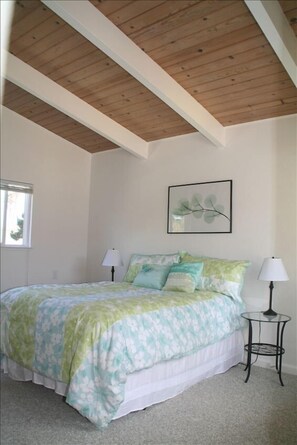 Light and airy master bedroom.  Fall asleep to the sound of the surf.