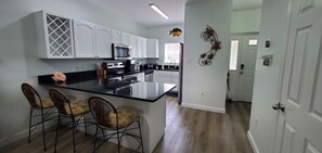 Fully stocked kitchen with stainless steel appliances and granite countertops. 