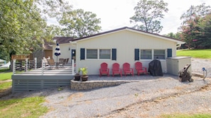 Side view of house. Large porch with patio furniture and grilling area. Lakeview