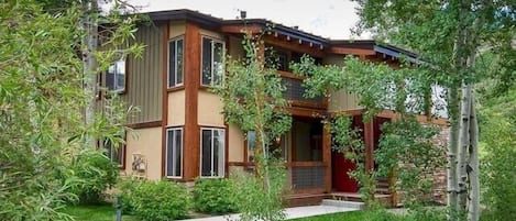 View of the condo (1st floor) nestled in the trees.