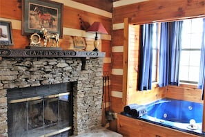 Stack stone fireplace with locally hand carved Black Walnut mantle.