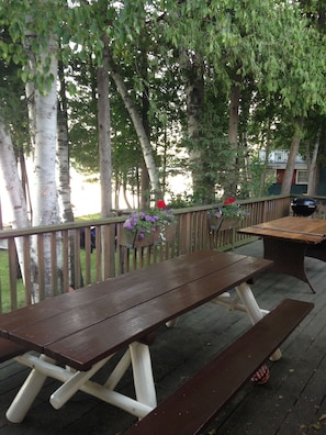 Huge deck with two picnic tables for outdoor dinners