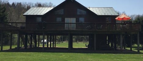 Large deck overlooks yard and river