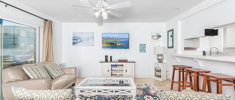 View of main living spaces from the front entry. Open floor plan between living, kitchen and dining areas.