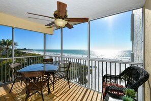 Lanai with table and chairs & love seat...stunning views of the azure waters of the Gulf and the powder white sands of World famous Crescent Beach.