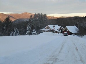View of the house, garage and Green Mountains beyond in winter