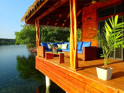 Over-the-water covered deck with lounge seating area with coffee table 