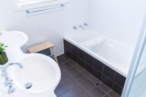 Bathroom 1 with double vanity, bath and shower.