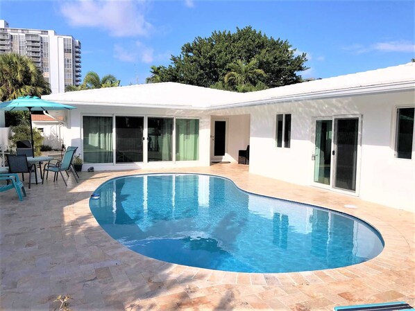 Stunning pool home is just steps to the beach.