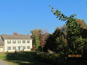 Front of house - in beautiful evening sun,  surrounded by woodland.