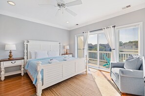 Main bedroom with sliding doors leading out to a private deck