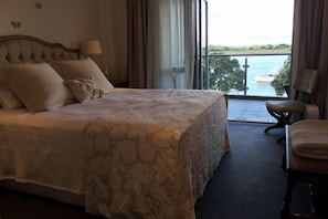 Main bedroom showing balcony access and water view