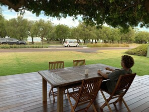 Sitting on the front deck enjoying the bay views, under lovely tree shade cover