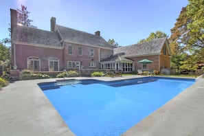 Pool is surrounded by beautiful perennial gardens and brick patios. Summer fun! 