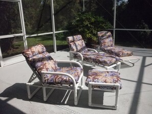 Chaise lounge chairs by the pool.