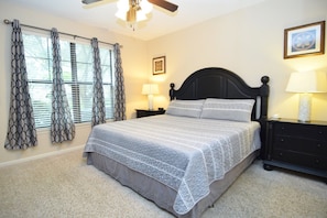 Spacious king room with Smart TV, fan, door to the patio and en suite bathroom