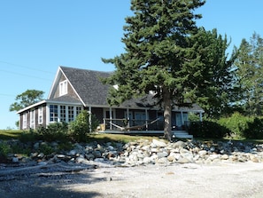 House from sandy beach exposed at mid to low tide