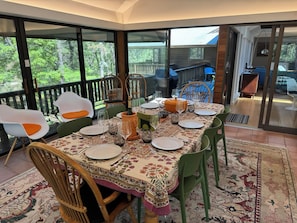 The all glass screened-in dining room is like eating in a treehouse.