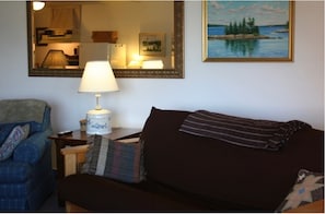 The living area has a futon and sleeper sofa.