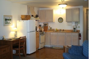 The kitchen includes a desk and chair….and everything you need to dine in.