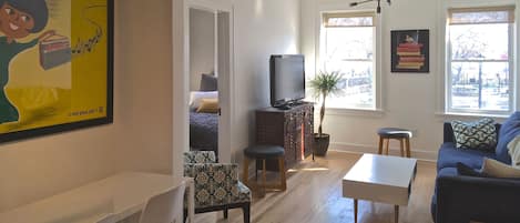 Living room with windows overlooking park.