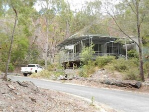 Side view of villa with parking facilities.