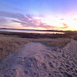 Ocean beach path with view of pond