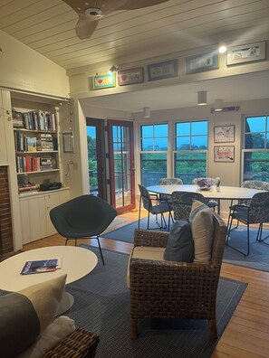 Living room and Dining room looking out over large deck and Quidnet Village