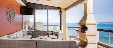 Indoor-outdoor living space features big ocean views, cable TV, and BBQ chimnea.