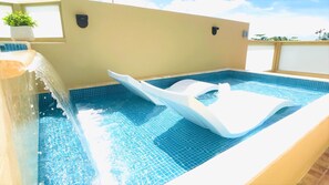 The pool's lower "tanning ledge," separated from the upper pool by a waterfall.