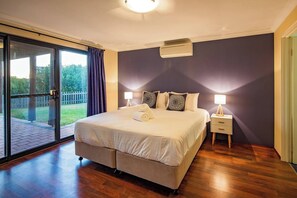 Wake up to fresh ocean air in this beautifully appointed king bedroom downstairs, featuring direct access to the outdoors.
