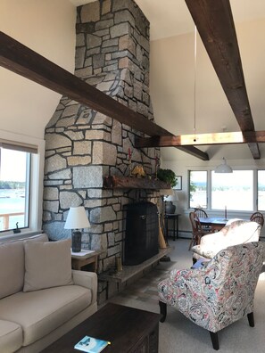 Living room area, sofa, chairs by fireplace 