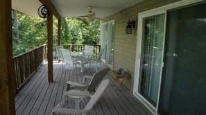 Huge covered deck great to relax rain or shine; fan and multiple tables